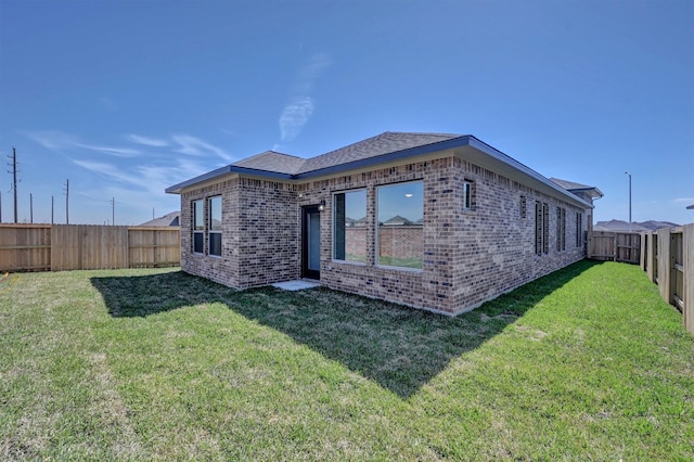 5028 Marcasca Dr, Katy, TX 77493 - rear view of house featuring a yard, brick siding, and a fenced backyard