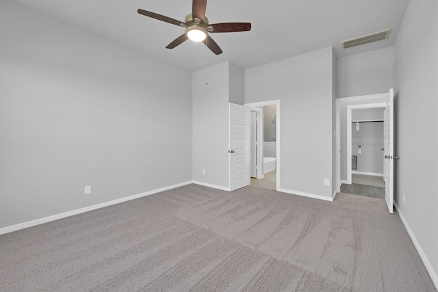 5028 Marcasca Dr, Katy, TX 77493 - unfurnished bedroom featuring visible vents, baseboards, a walk in closet, ensuite bath, and carpet flooring
