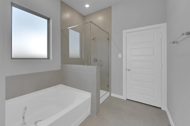 5028 Marcasca Dr, Katy, TX 77493 - full bath with tile patterned floors, a bath, a stall shower, and baseboards