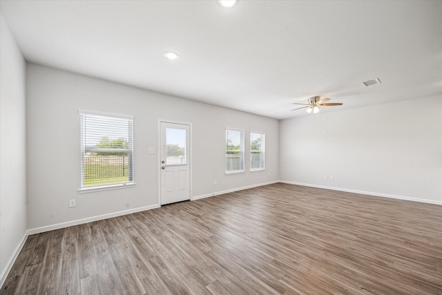 12260 Lady Eli Dr, Willis, TX 77318 - unfurnished living room with wood finished floors, ceiling fan, and recessed lighting
