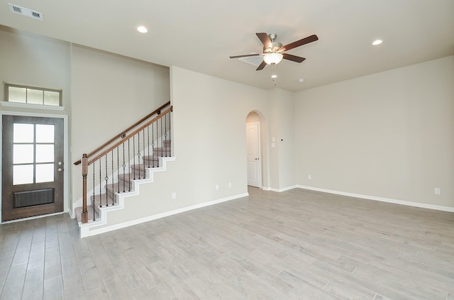 5203 Prairie Terrace Ln, Fulshear, TX 77441 - unfurnished living room featuring light wood-type flooring, recessed lighting, arched walkways, visible vents, and a ceiling fan