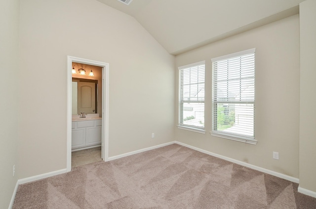 5203 Prairie Terrace Ln, Fulshear, TX 77441 - unfurnished bedroom featuring baseboards, lofted ceiling, ensuite bath, and light colored carpet