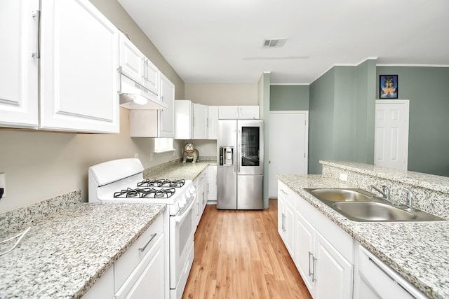 11314 Carla St, Houston, TX 77076 - kitchen with visible vents, white appliances, white cabinetry, a sink, and light wood-type flooring