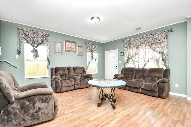 11314 Carla St, Houston, TX 77076 - living area featuring wood finished floors, ornamental molding, baseboards, and visible vents