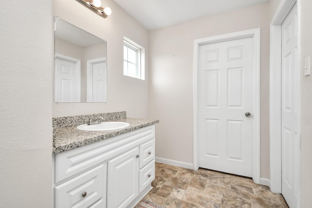 11314 Carla St, Houston, TX 77076 - bathroom with vanity, stone finish floor, and baseboards