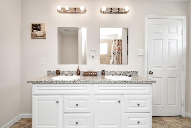 11314 Carla St, Houston, TX 77076 - bathroom with double vanity, baseboards, and a sink