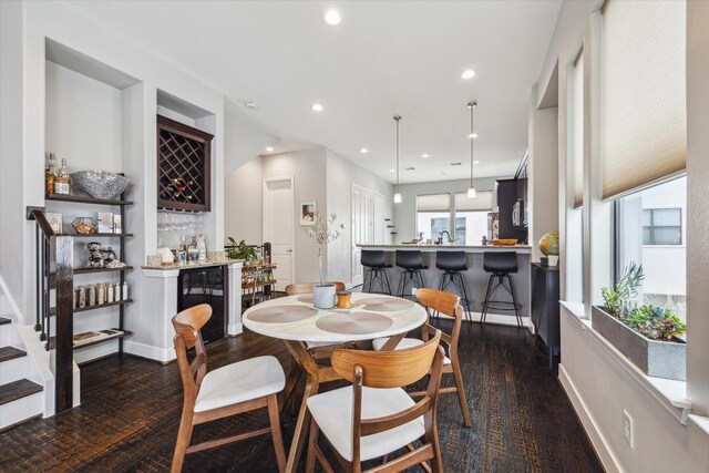 2718 Leeland St Unit A, Houston, TX 77003 - dining space featuring beverage cooler, a dry bar, recessed lighting, baseboards, and dark wood-type flooring
