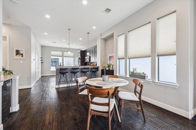 2718 Leeland St Unit A, Houston, TX 77003 - dining area with beverage cooler, recessed lighting, baseboards, and dark wood-style flooring