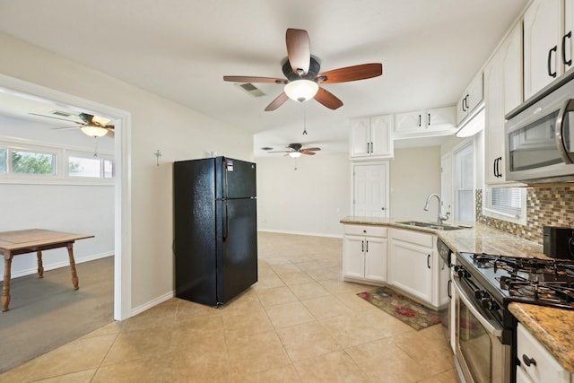 kitchen featuring white cabinets, a sink, a ceiling fan, and appliances with stainless steel finishes