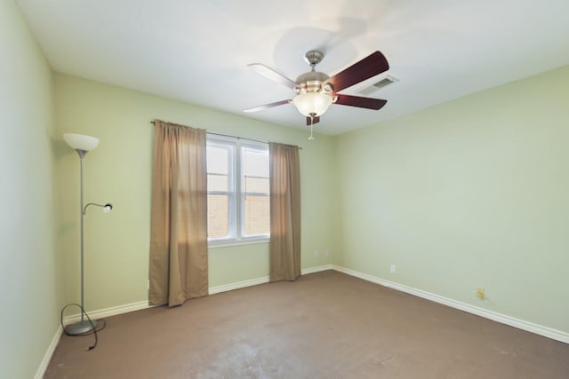 carpeted empty room with baseboards, ceiling fan, and visible vents