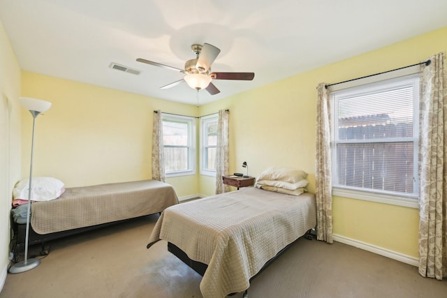 bedroom featuring a ceiling fan, carpet, baseboards, and visible vents