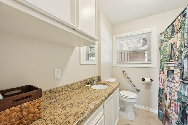 bathroom with tile patterned flooring, vanity, toilet, and baseboards
