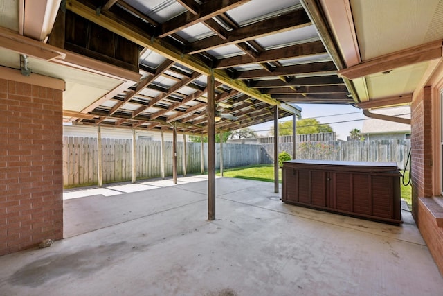 view of patio / terrace featuring a hot tub and a fenced backyard