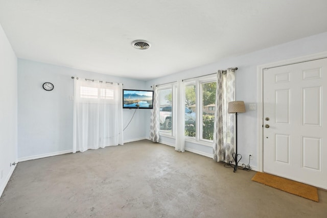 unfurnished room with baseboards, visible vents, and concrete flooring