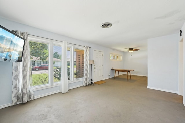 unfurnished room with concrete floors, baseboards, ceiling fan, and visible vents