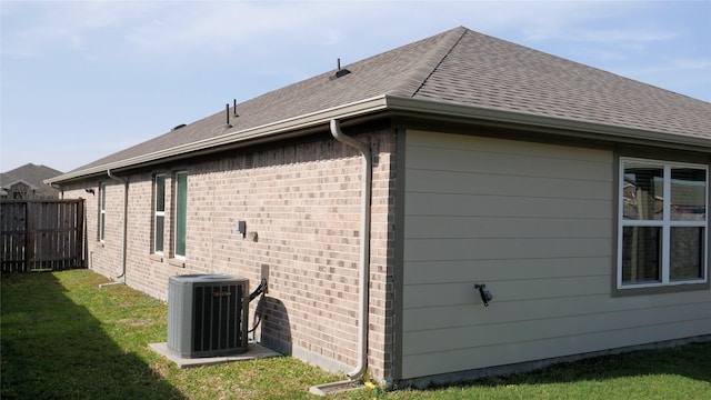 1807 Iris Knoll Ln, Pearland, TX 77089 - view of side of property with cooling unit, a yard, fence, and brick siding