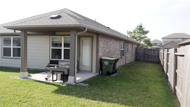 1807 Iris Knoll Ln, Pearland, TX 77089 - rear view of property with a yard, a fenced backyard, a patio, brick siding, and a shingled roof