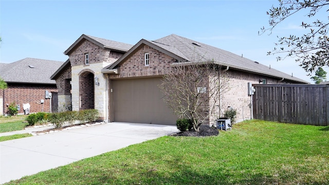 1807 Iris Knoll Ln, Pearland, TX 77089 - view of front of home with fence, a front lawn, brick siding, an attached garage, and driveway