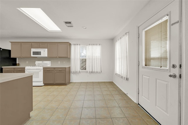 2904 Bristol Bend Ln, Dickinson, TX 77539 - kitchen with white appliances, light countertops, light tile patterned floors, and baseboards