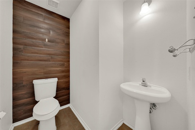 2904 Bristol Bend Ln, Dickinson, TX 77539 - half bathroom with toilet, tile patterned floors, wooden walls, and baseboards