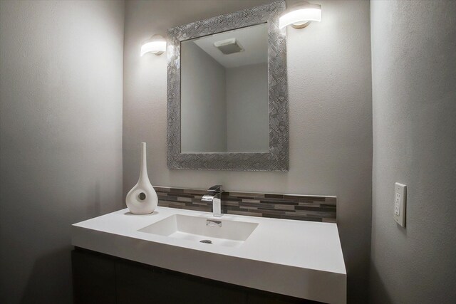 bathroom with backsplash and vanity