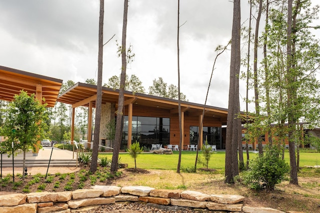 12830 Forest Garden Ct, Conroe, TX 77302 - back of house with a lawn