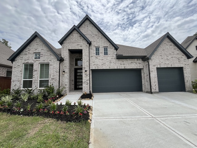 12830 Forest Garden Ct, Conroe, TX 77302 - french country home featuring brick siding, driveway, a garage, and a shingled roof