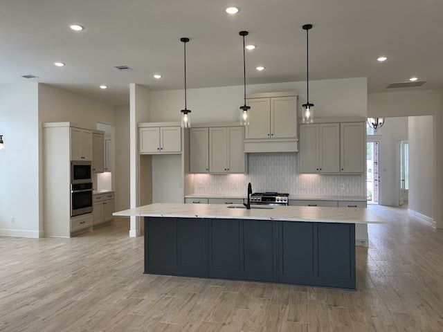 12830 Forest Garden Ct, Conroe, TX 77302 - kitchen with tasteful backsplash, a large island, light wood-style floors, recessed lighting, and decorative light fixtures