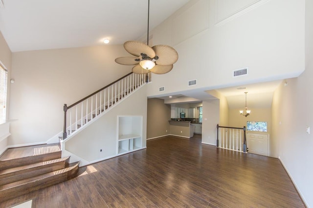 737 Davis Rd, League City, TX 77573 - unfurnished living room with visible vents, a towering ceiling, wood finished floors, and stairs