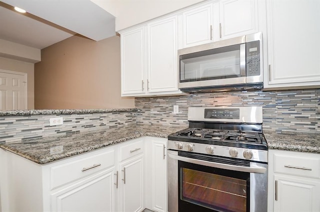 737 Davis Rd, League City, TX 77573 - kitchen with stainless steel appliances, white cabinetry, and decorative backsplash