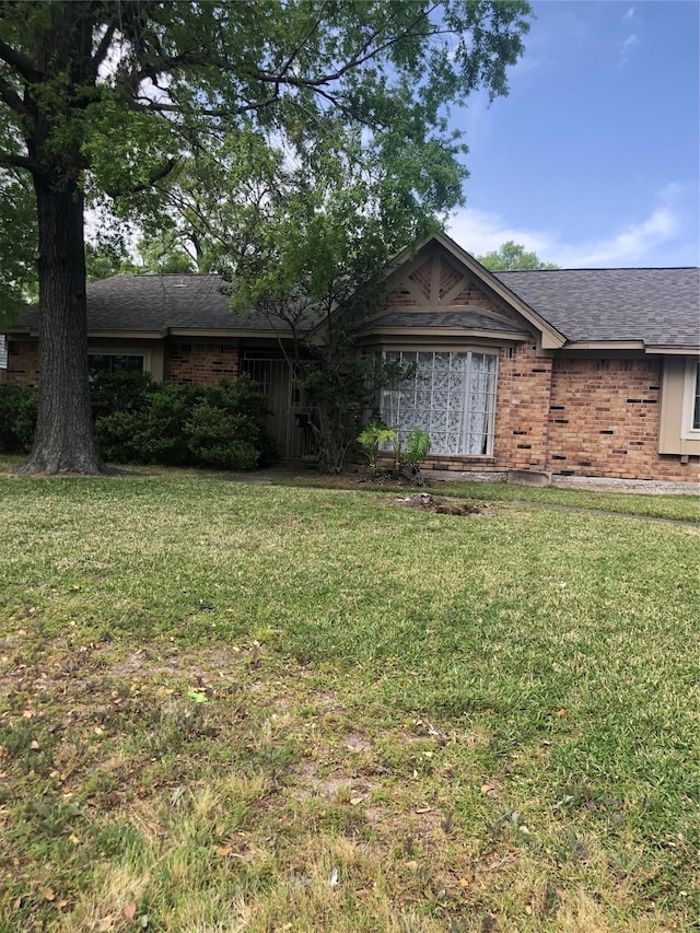 14407 Duncannon Dr, Houston, TX 77015 - single story home featuring brick siding, a shingled roof, and a front yard