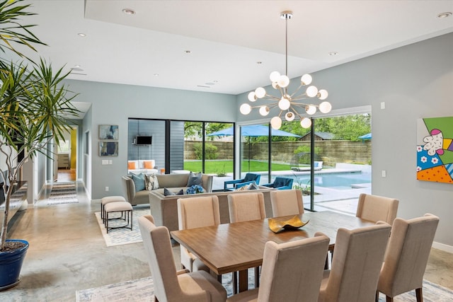dining space with a chandelier, plenty of natural light, finished concrete floors, and baseboards