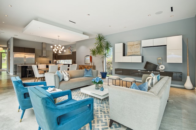 living area featuring a chandelier, recessed lighting, finished concrete floors, and a healthy amount of sunlight