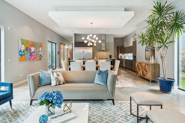 living area featuring a chandelier, recessed lighting, baseboards, and a wealth of natural light