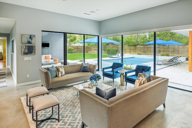 living room featuring baseboards and finished concrete flooring