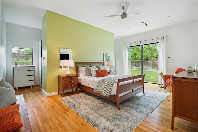 bedroom with access to outside, ceiling fan, visible vents, and light wood-style flooring