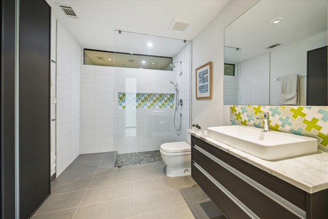 full bathroom featuring toilet, a walk in shower, recessed lighting, vanity, and tile patterned flooring