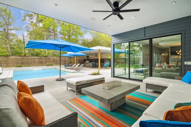 view of pool featuring a fenced in pool, an outdoor living space, a patio area, a fenced backyard, and ceiling fan
