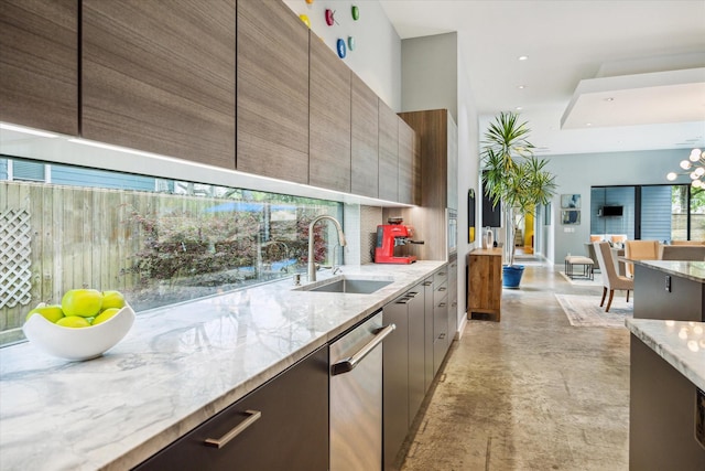 kitchen with modern cabinets, light stone countertops, dishwasher, a sink, and decorative backsplash