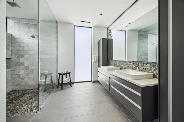 full bathroom featuring decorative backsplash, a sink, walk in shower, tile patterned floors, and double vanity