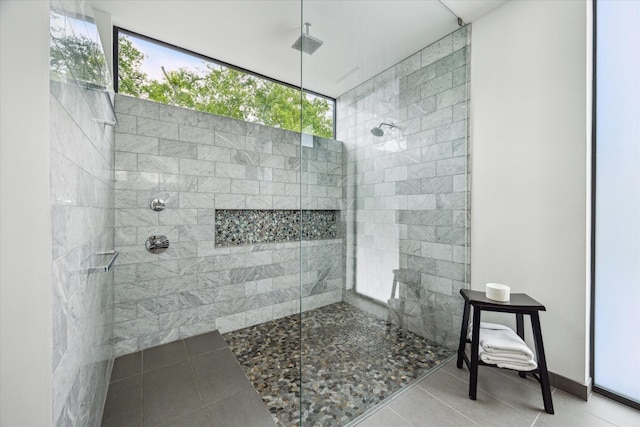 bathroom featuring a walk in shower and tile patterned flooring