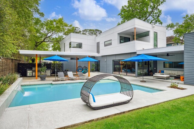 rear view of property with a patio area, a fenced in pool, fence, and a balcony