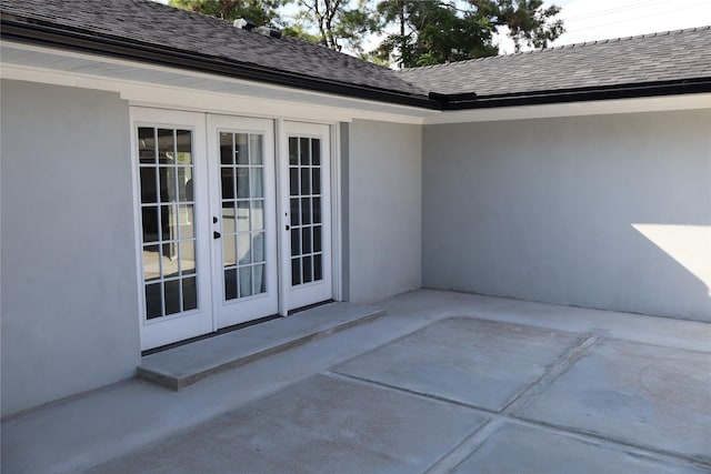 9121 Fordshire Dr, Houston, TX 77025 - doorway to property featuring french doors, a patio, and stucco siding