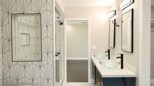 9121 Fordshire Dr, Houston, TX 77025 - full bathroom featuring double vanity, a sink, and a stall shower