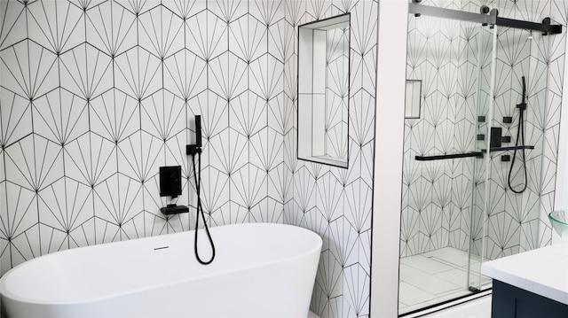 9121 Fordshire Dr, Houston, TX 77025 - bathroom with a shower stall, vanity, tile walls, and a soaking tub