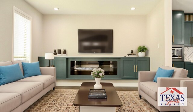 9121 Fordshire Dr, Houston, TX 77025 - living area with recessed lighting, a fireplace, wood finished floors, and a healthy amount of sunlight