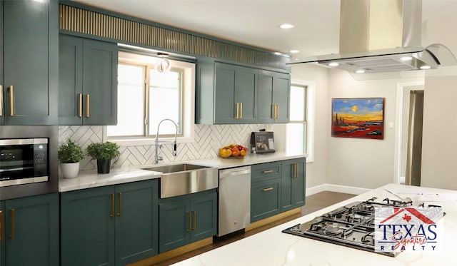 9121 Fordshire Dr, Houston, TX 77025 - kitchen featuring tasteful backsplash, a sink, appliances with stainless steel finishes, island range hood, and green cabinets