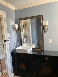 bathroom featuring ornamental molding and vanity