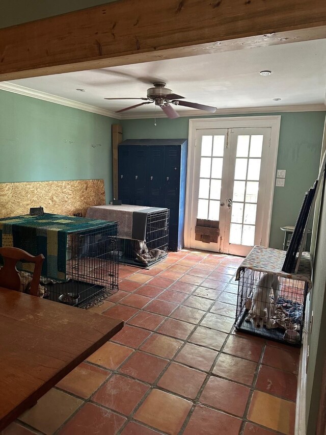 tiled living area featuring french doors, crown molding, and a ceiling fan