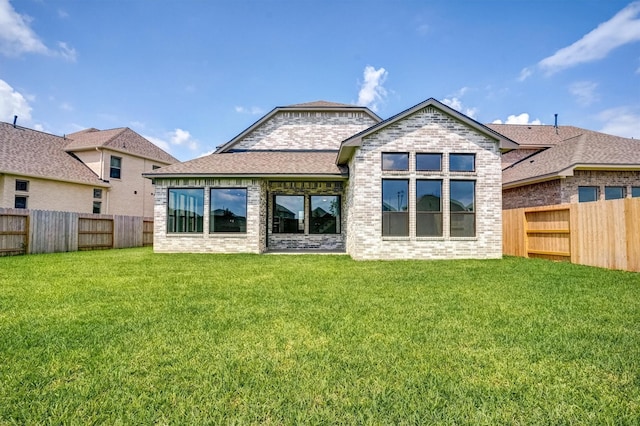 2904 Apple Rose, Katy, TX 77493 - rear view of house featuring a shingled roof, brick siding, a lawn, and a fenced backyard